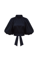 Navy blue Elara crop top by ANA + MARIA, featuring a stylish fit and soft fabric, shown on a model in a fashion photo.