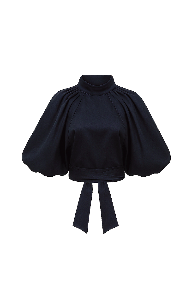 Navy blue Elara crop top by ANA + MARIA, featuring a stylish fit and soft fabric, shown on a model in a fashion photo.