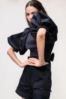 Navy blue Elara crop top by ANA + MARIA, featuring a fitted design and scoop neckline, displayed on a plain background.