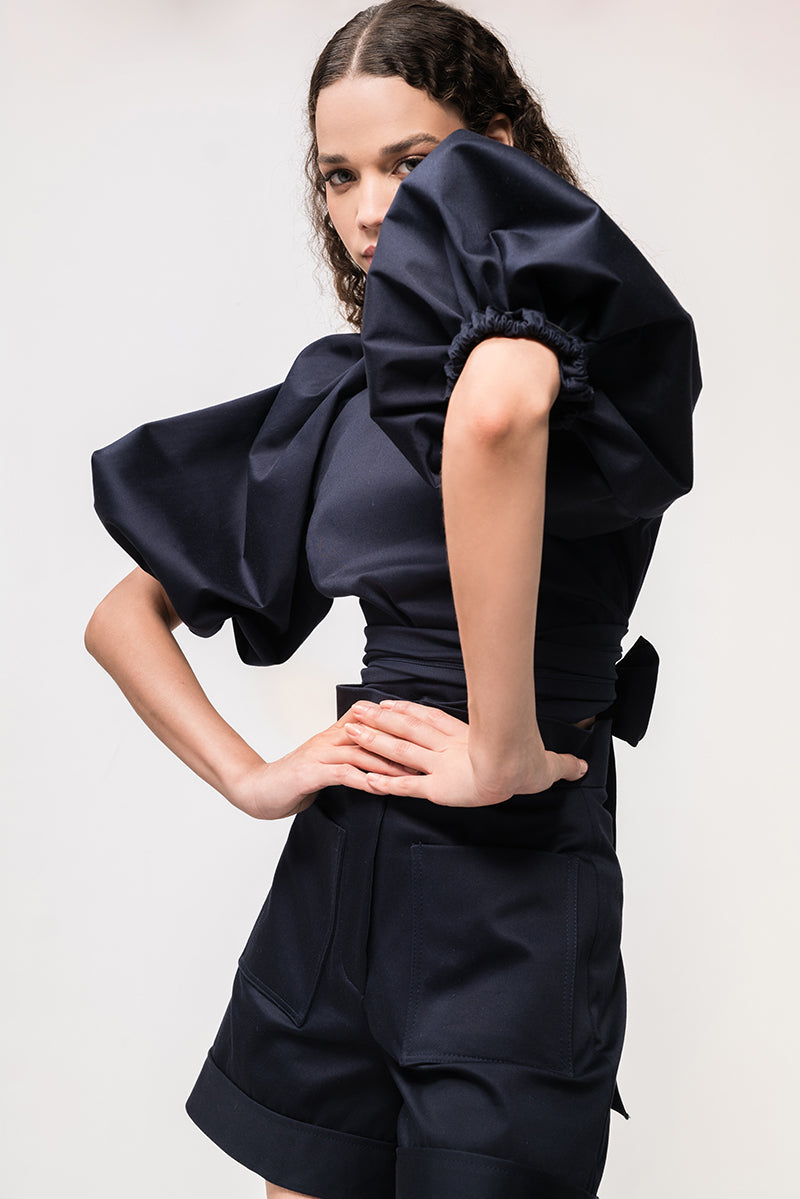 Navy blue Elara crop top by ANA + MARIA, featuring a fitted design and scoop neckline, displayed on a plain background.
