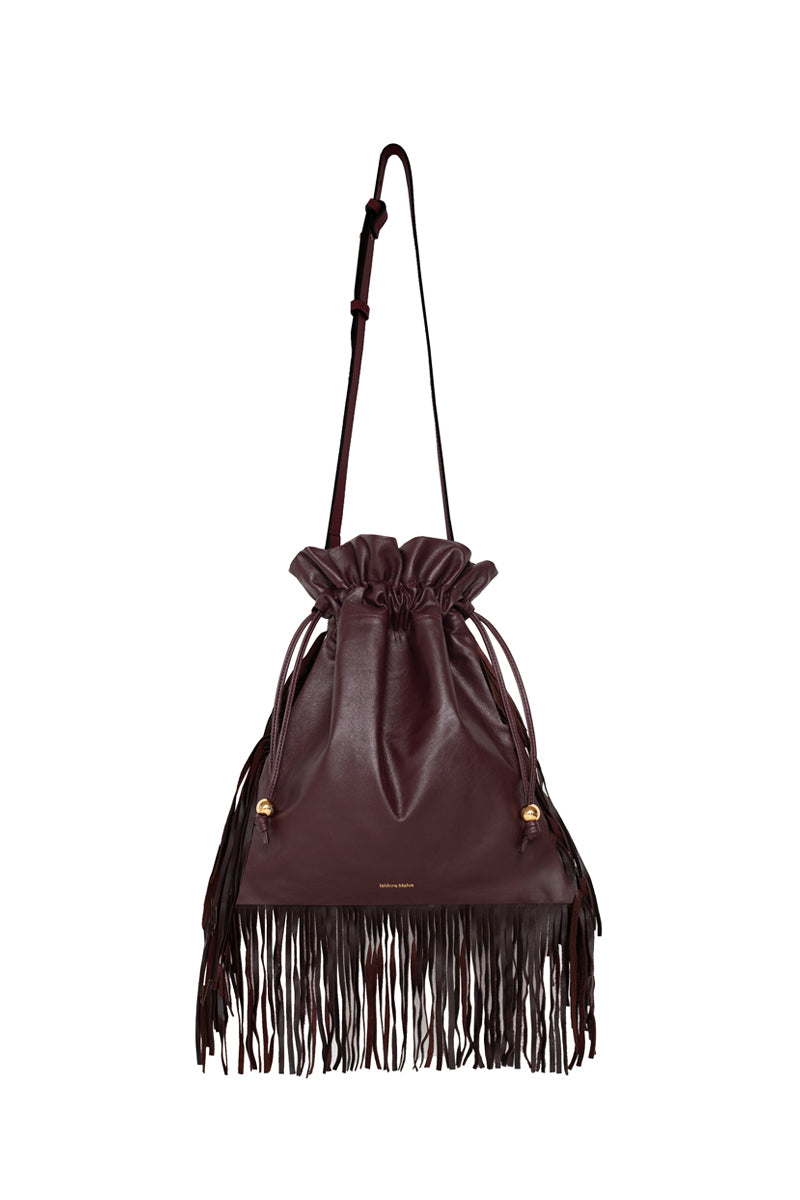 ISIDORA MALVA burgundy Elena pouch top handle bag with fringe detailing, showcasing its elegant design and compact size.