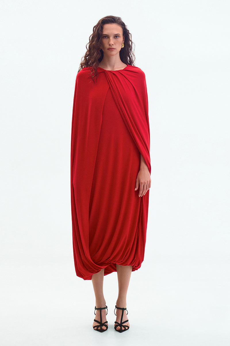 Red jersey midi cape dress by ElenaReva featuring a flowing silhouette and elegant design.