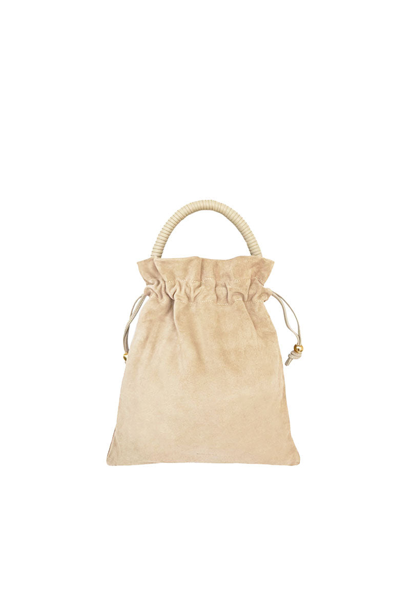 ISIDORA MALVA Elena suede pouch in nude with top handle, showcasing its elegant, soft suede material and compact design.