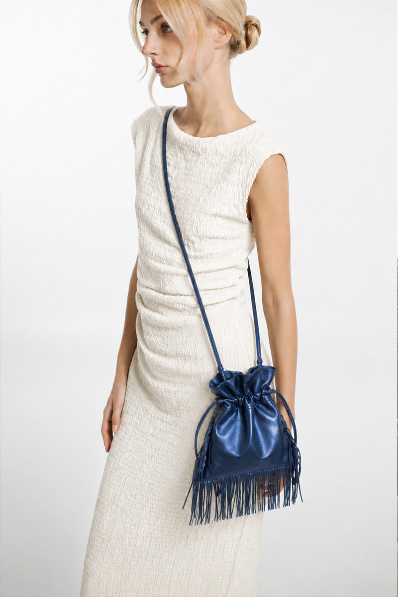 Electric blue Elena mini shoulder bag with fringe detailing by ISIDORA MALVA, showing the bag's compact design and vibrant color.