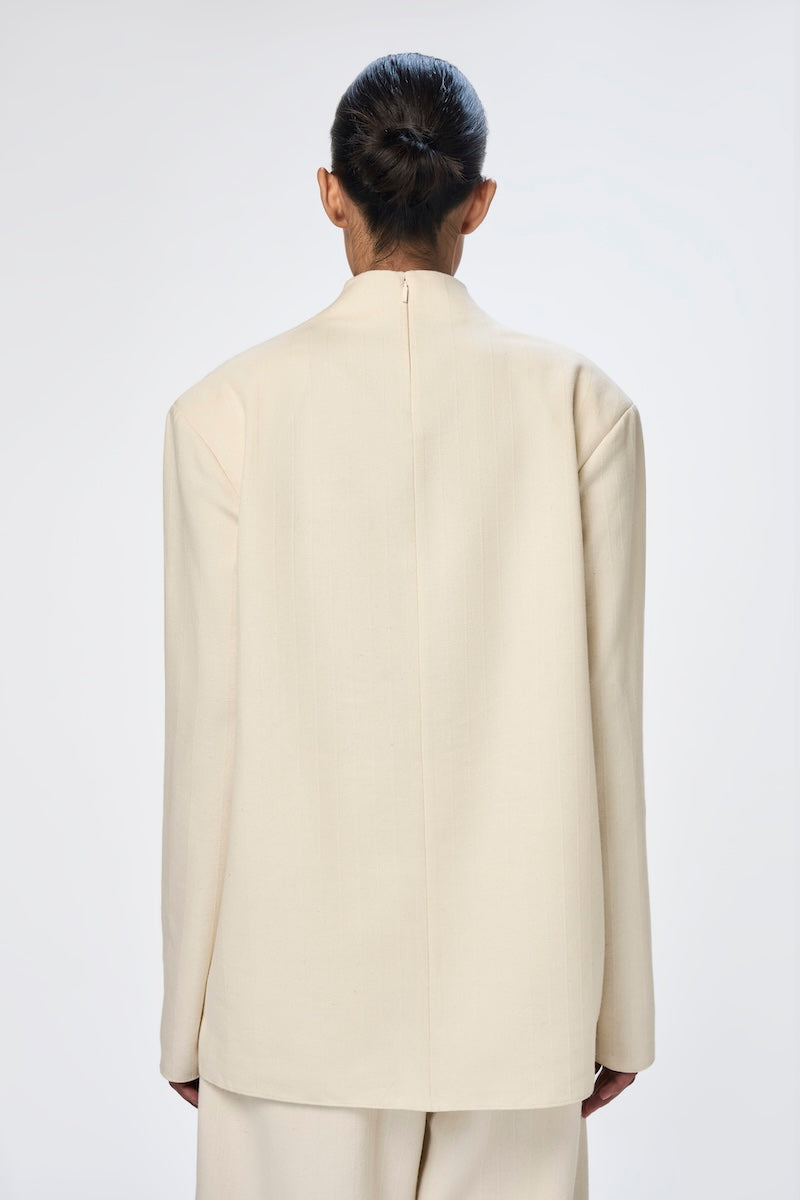 White silk Eli Top by URA, stylish and elegant women's top featuring smooth fabric and a modern design.