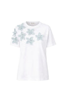 Light blue ELIA T-shirt from ANA + MARIA, casual top with a ghost-themed graphic design, displayed on a plain background.