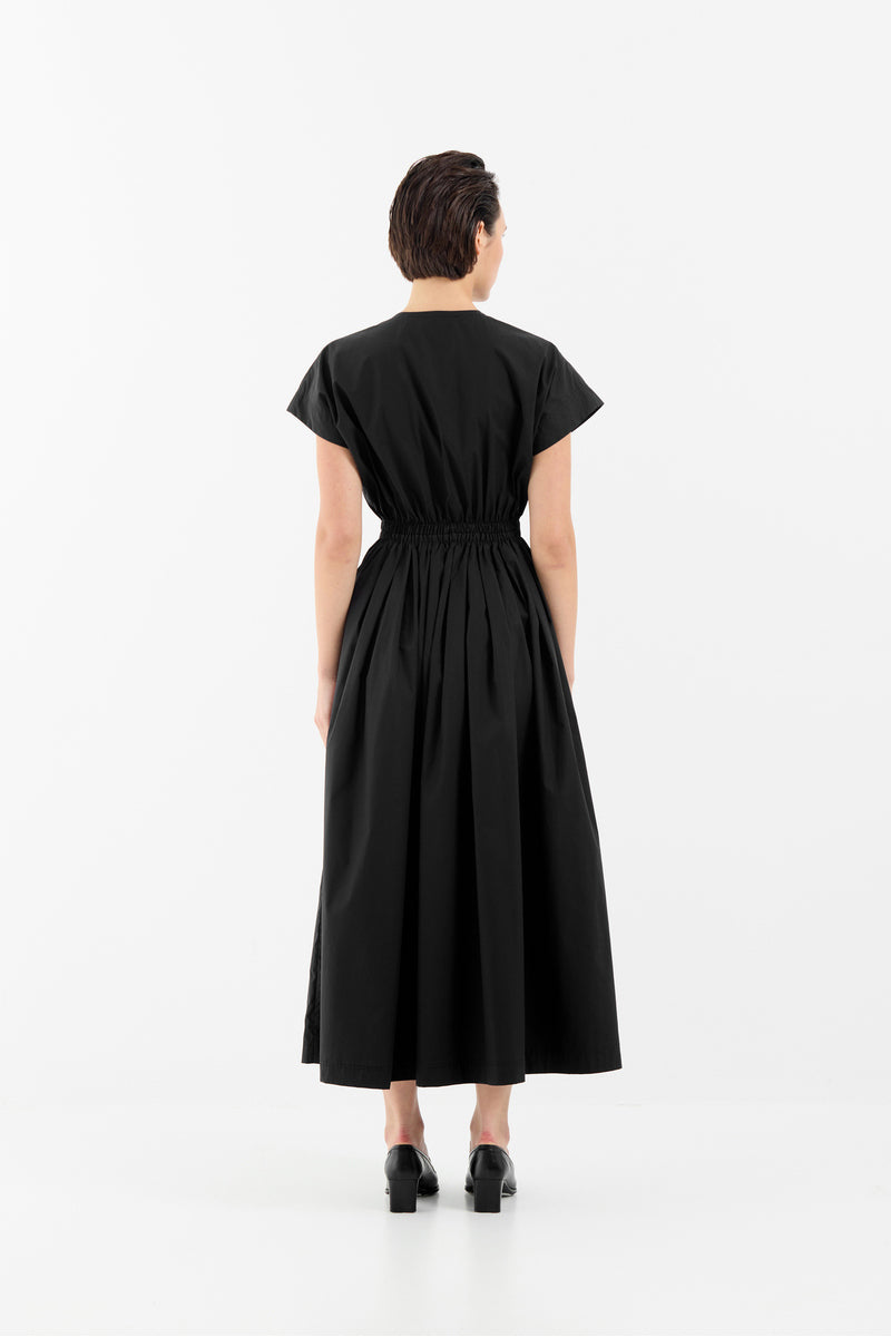 Black Tamar Keburia Eliz maxi dress displayed on a model with flowing fabric and elegant design.