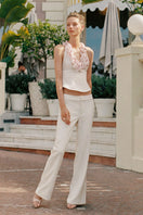 Nana Jacqueline Ella flared pants in champagne fabric, stylish and comfortable, shown on a model in a fashion campaign.