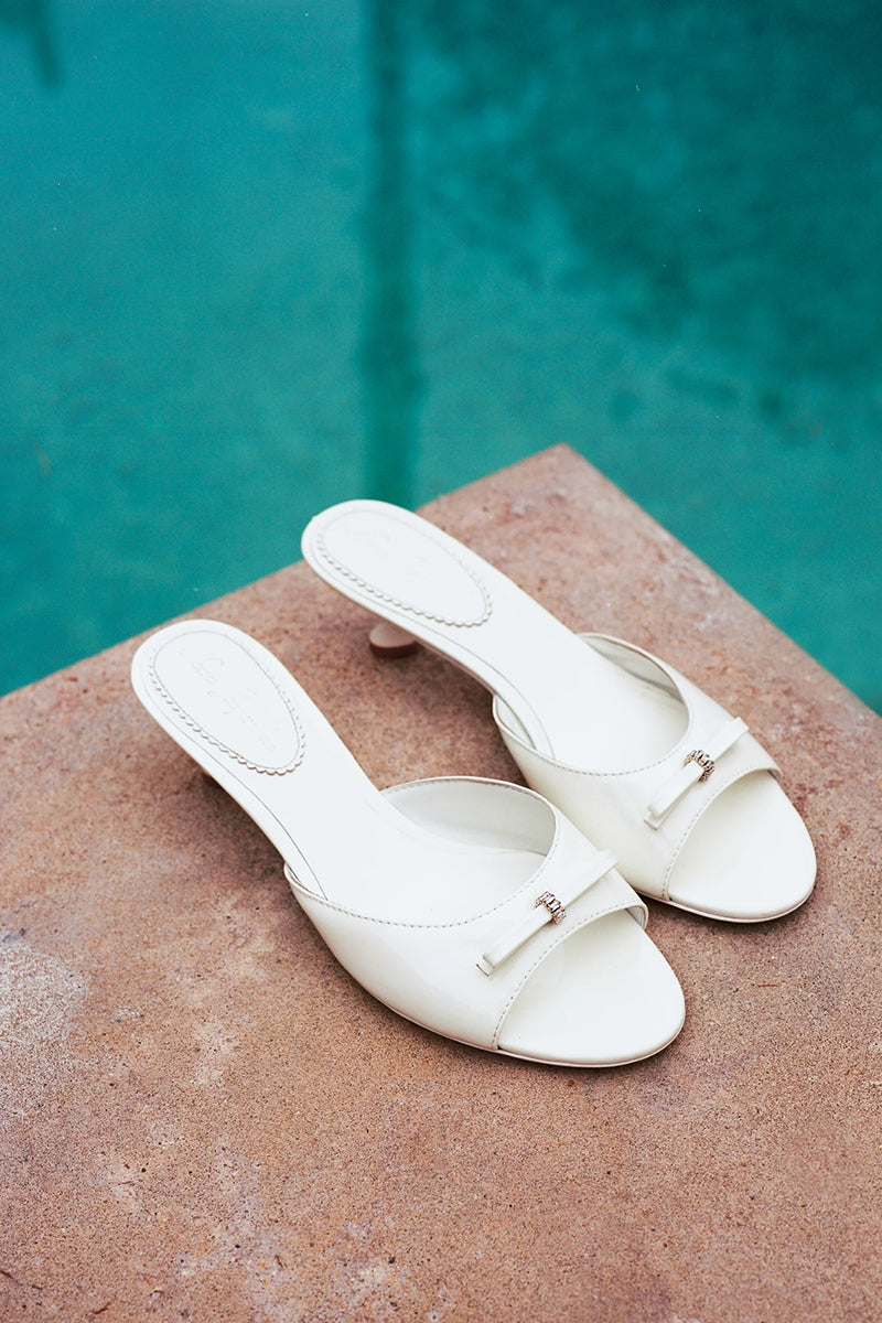 White Nana Jacqueline Ella Heart Heels with elegant design, showcasing stylish footwear on a model for a fashion campaign image.