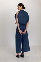 Dark blue Ellen bib top by ANA + MARIA, featuring a stylish and comfortable design, shown on a model in a fashion photoshoot.