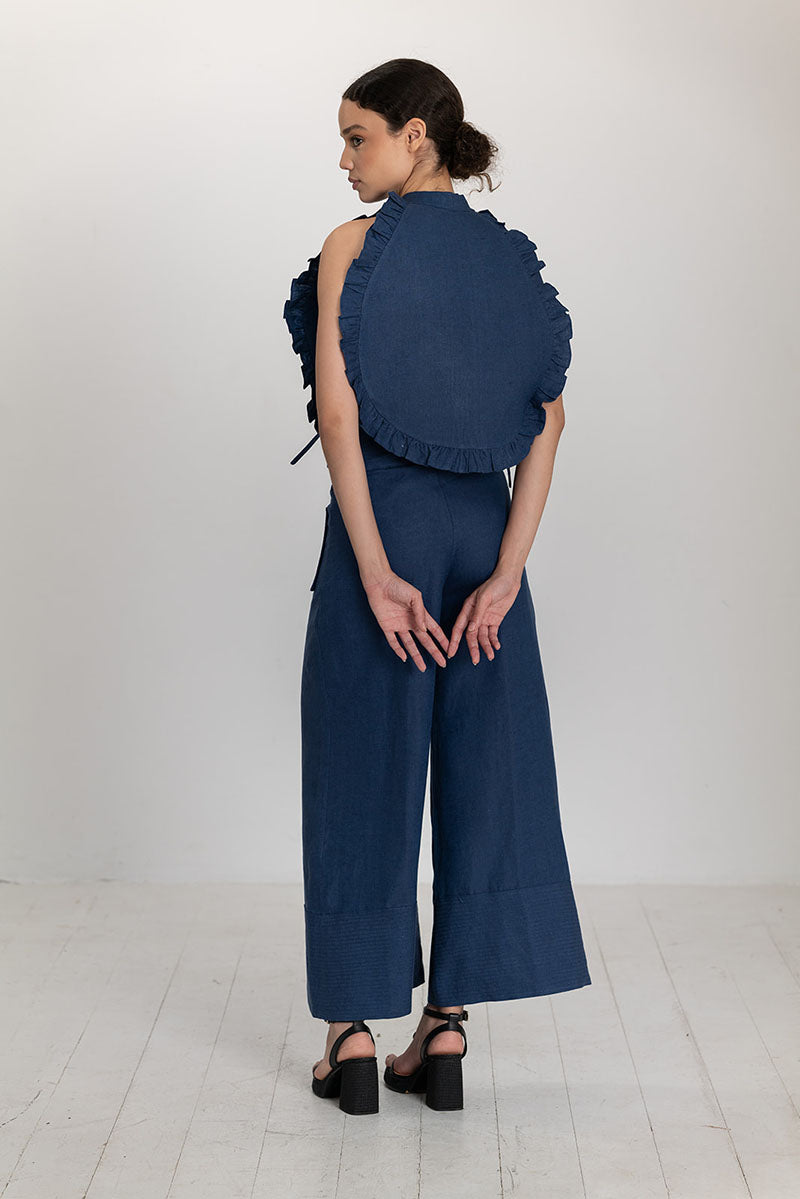 Dark blue Ellen bib top by ANA + MARIA, featuring a stylish and comfortable design, shown on a model in a fashion photoshoot.