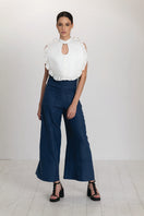 Ivory Ellen Bib from ANA + MARIA, a stylish top with elegant design and soft fabric, shown on a model.