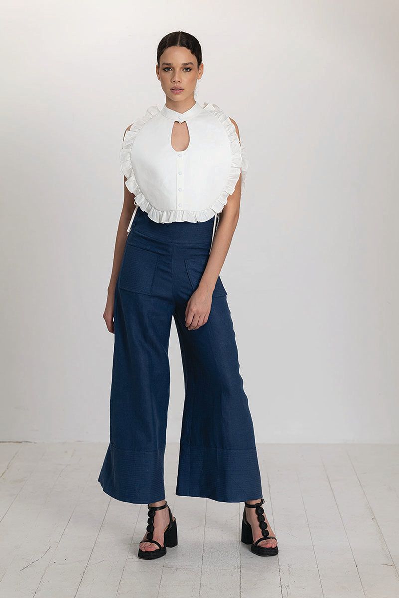 Ivory Ellen Bib from ANA + MARIA, a stylish top with elegant design and soft fabric, shown on a model.