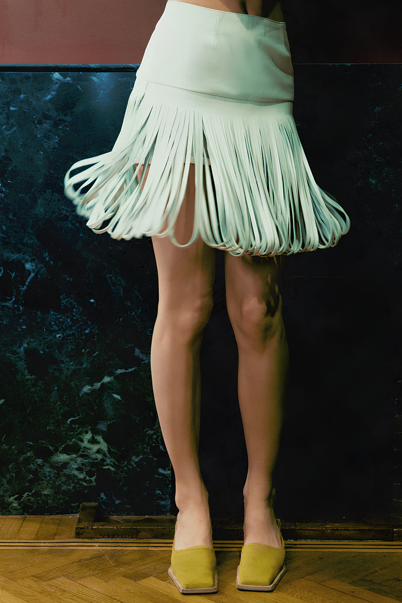 White Ellie leather midi skirt by Double A, shown with a sleek, fitted design and smooth leather texture.