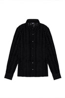 Black embossed tulle shirt by Bassigue, featuring textured fabric and a stylish, semi-sheer design on a model.