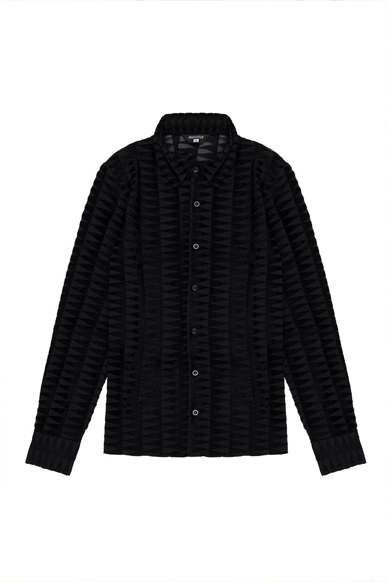 Black embossed tulle shirt by Bassigue, featuring textured fabric and a stylish, semi-sheer design on a model.