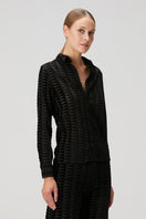 Black embossed tulle shirt by Bassigue featuring textured, semi-sheer fabric and a stylish, fitted design with long sleeves.
