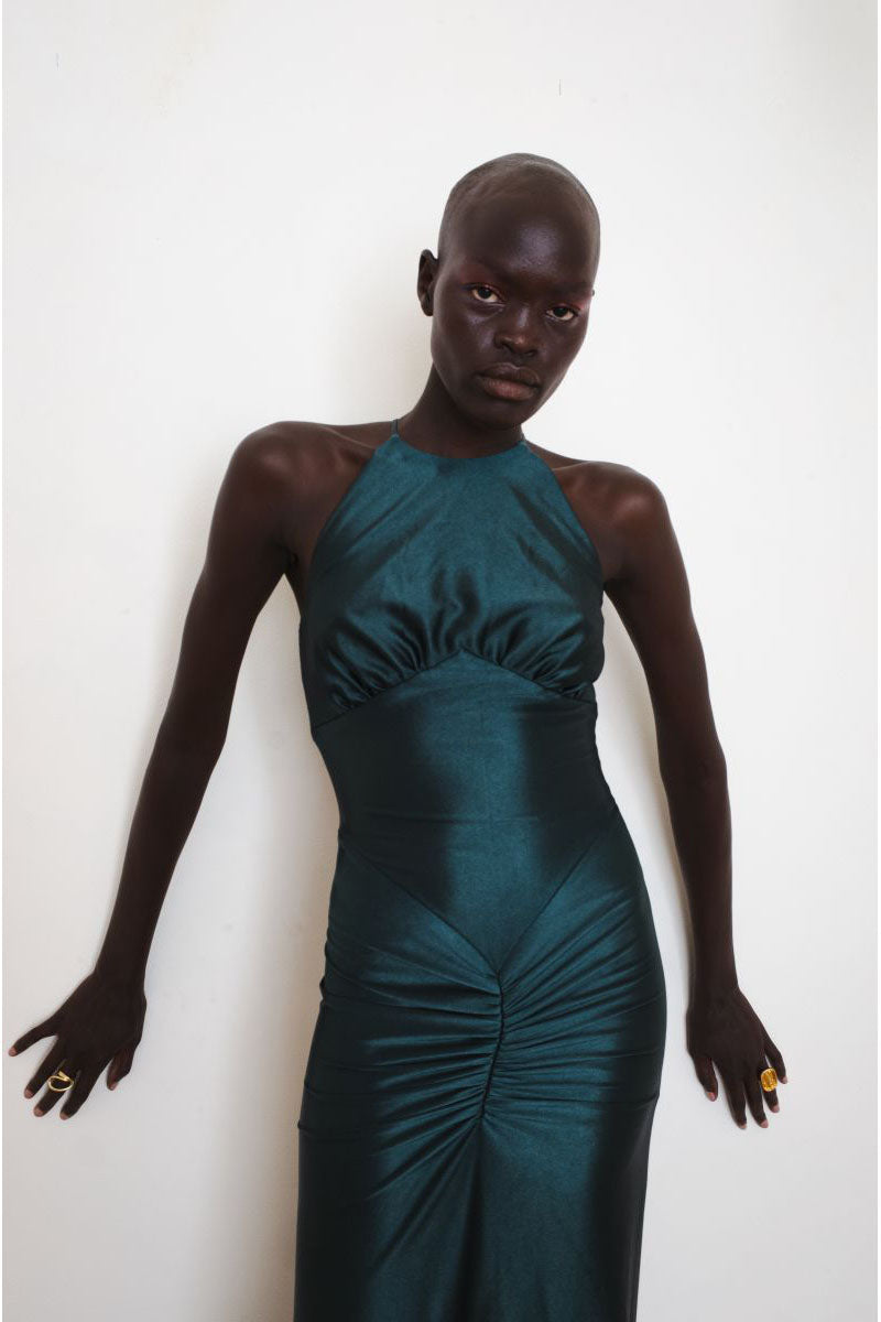 Close-up of YASSMIN SALEH Embrace teal gown showcasing elegant fabric and detailed design.