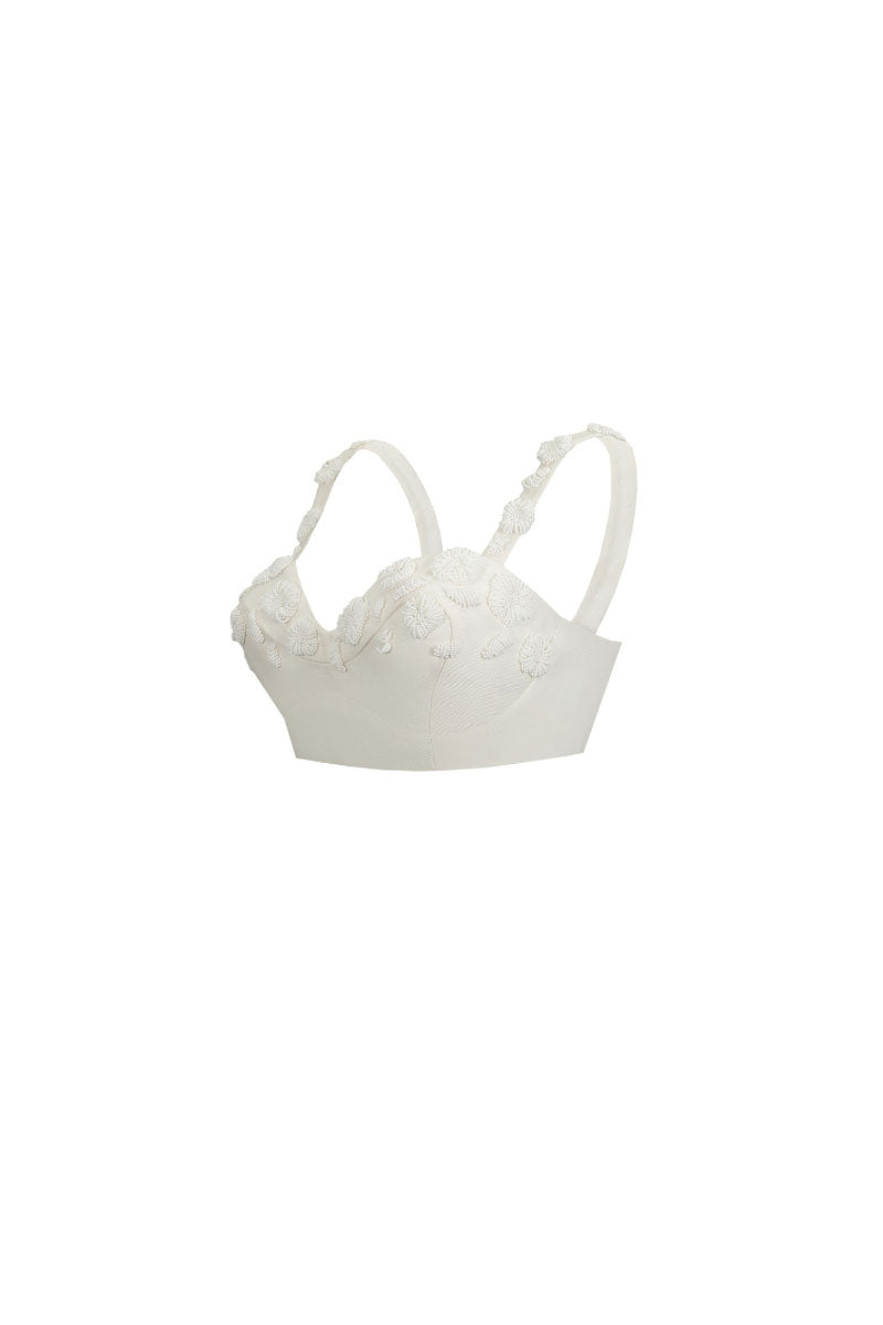 White embroidered top from Santa Brands, featuring detailed stitching and a stylish, casual design.
