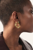 Gold earrings featuring open mini wave design with emerald accents, by Fenomena, showcasing elegant jewelry craftsmanship.
