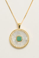 Emerald birthstone necklace by Freya Rose featuring a gold vermeil chain with a green emerald and mother-of-pearl pendant.