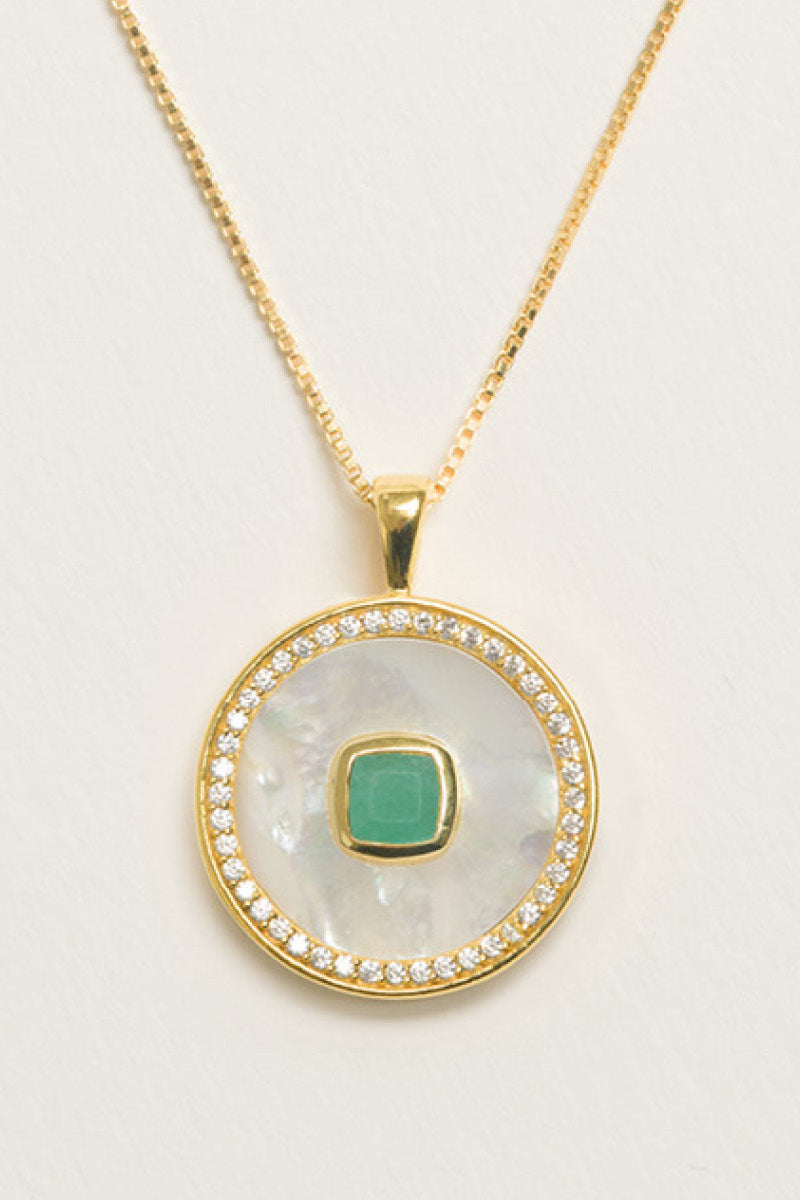 Emerald birthstone necklace by Freya Rose featuring a gold vermeil chain with a green emerald and mother-of-pearl pendant.