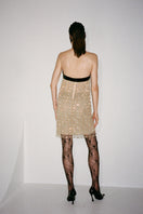 Nué Daisy Dress mini dress displayed on a hanger, featuring a floral pattern and lightweight fabric perfect for summer wear.