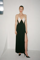 Nué Perla black maxi dress displayed on a hanger, showcasing its elegant, flowing fabric and stylish design.