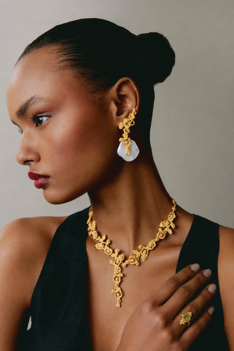 Jude Benhalim erosion earrings in white and gold featuring a textured, organic design with a modern, elegant look.