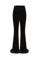 Black velvet pants by Nana Jacqueline with a relaxed fit, shown from the back view in this stylish fashion image.
