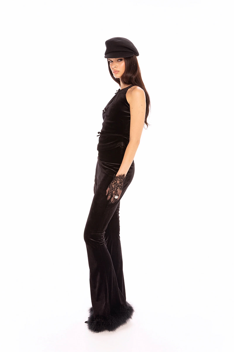 Black velvet pants by Nana Jacqueline featuring a sleek, tailored fit and smooth fabric, showcased in a fashion lookbook image.
