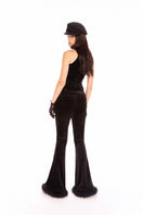 Black velvet pants by Nana Jacqueline, stylish and comfortable, shown on a model in a fashion lookbook image.