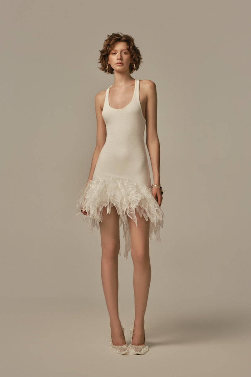 White Éther Mini Dress by POEM, featuring a stylish short dress design worn by a model.