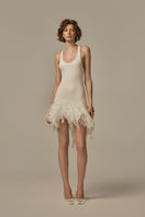 White POEM ÉTHER MINI DRESS on a model, showcasing a stylish short dress with a fitted silhouette and elegant design.