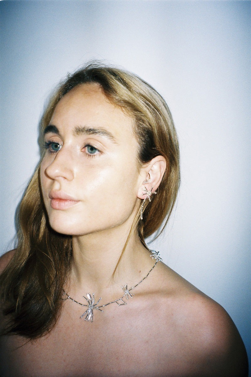 Silver dandelion necklace by Pura Utz featuring a delicate dandelion pendant on a fine chain.