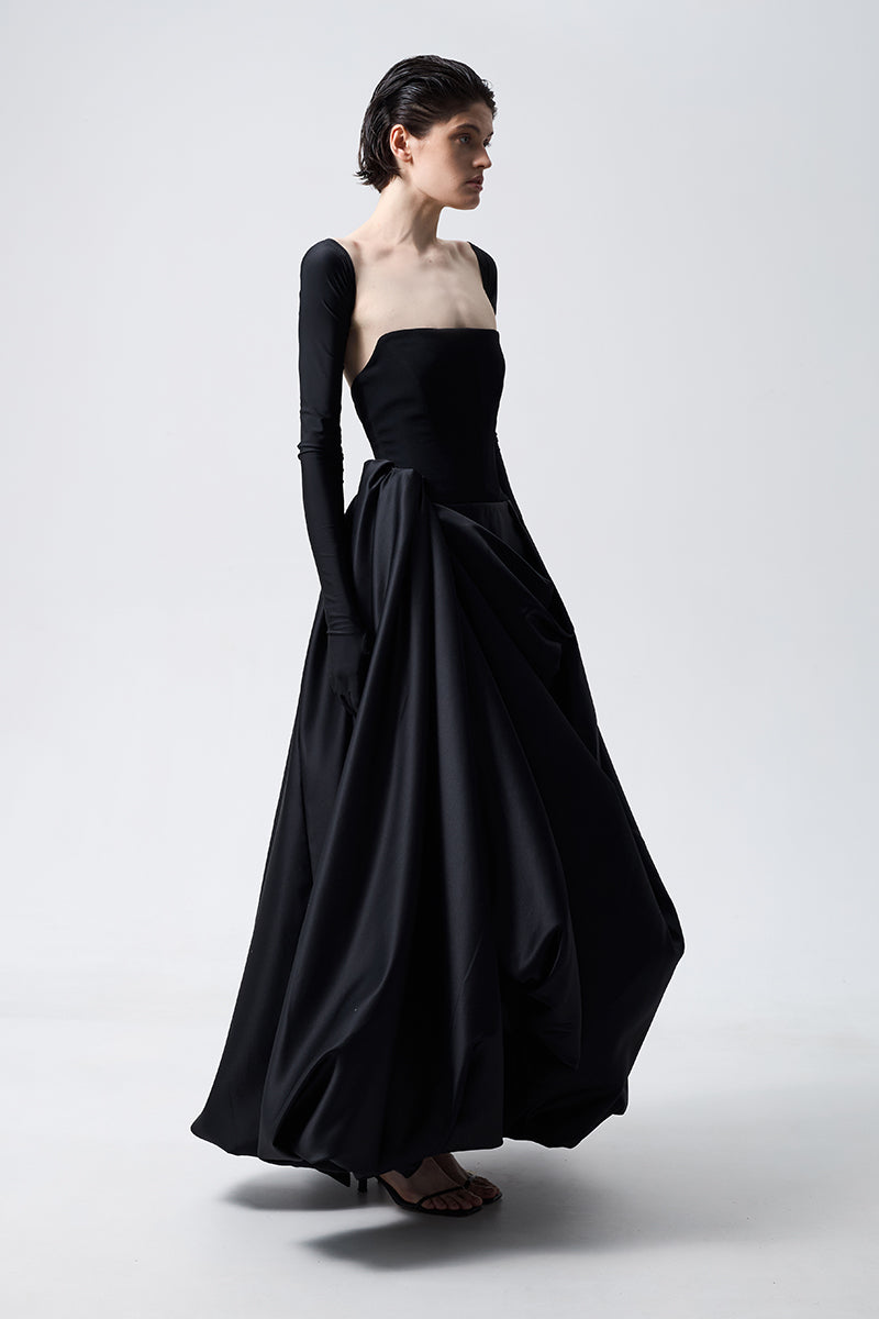Black Monetre asymmetrical gown with flowing fabric and unique hemline, elegant and stylish for formal occasions.