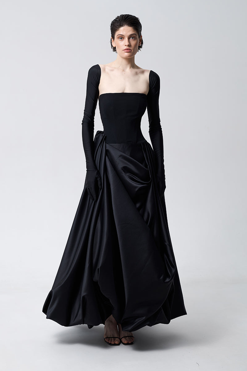 Black asymmetrical gown by Monetre featuring a stylish, flowing design with unique hemline and elegant silhouette.