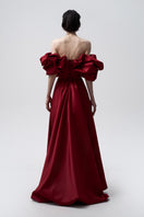 Elegant Bordo meringue gown by Monetre featuring flowing fabric and intricate detailing perfect for formal occasions.