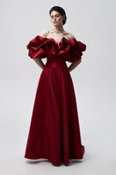 Elegant Bordo meringue gown by Monetre featuring flowing fabric and intricate detailing, perfect for formal occasions.