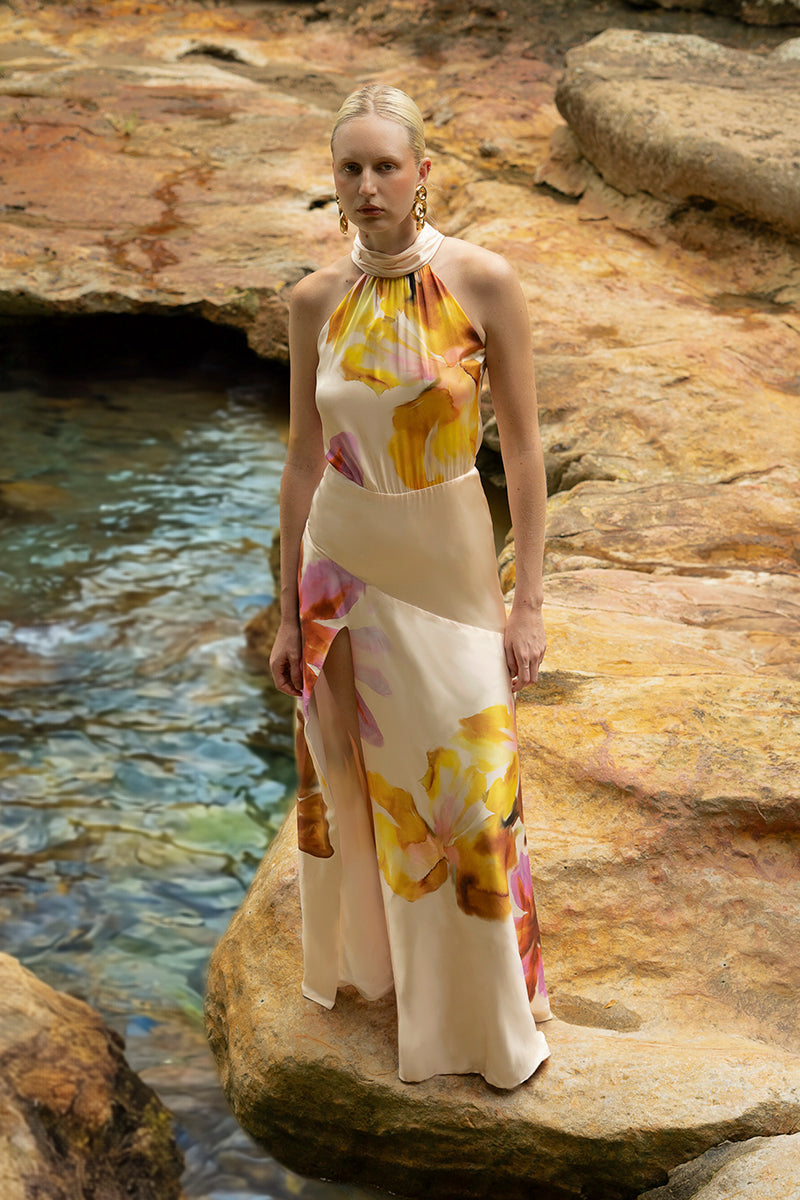 Floral maxi dress from Tinta Latina featuring a flowing design and vibrant floral pattern, perfect for elegant summer wear.