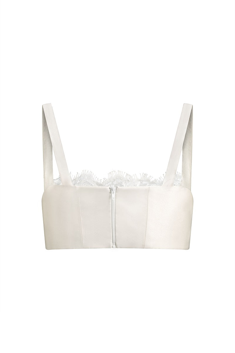 Scarlett Gasque Fiorella bralette top featuring delicate lace fabric and feminine design, shown hanging on a display.