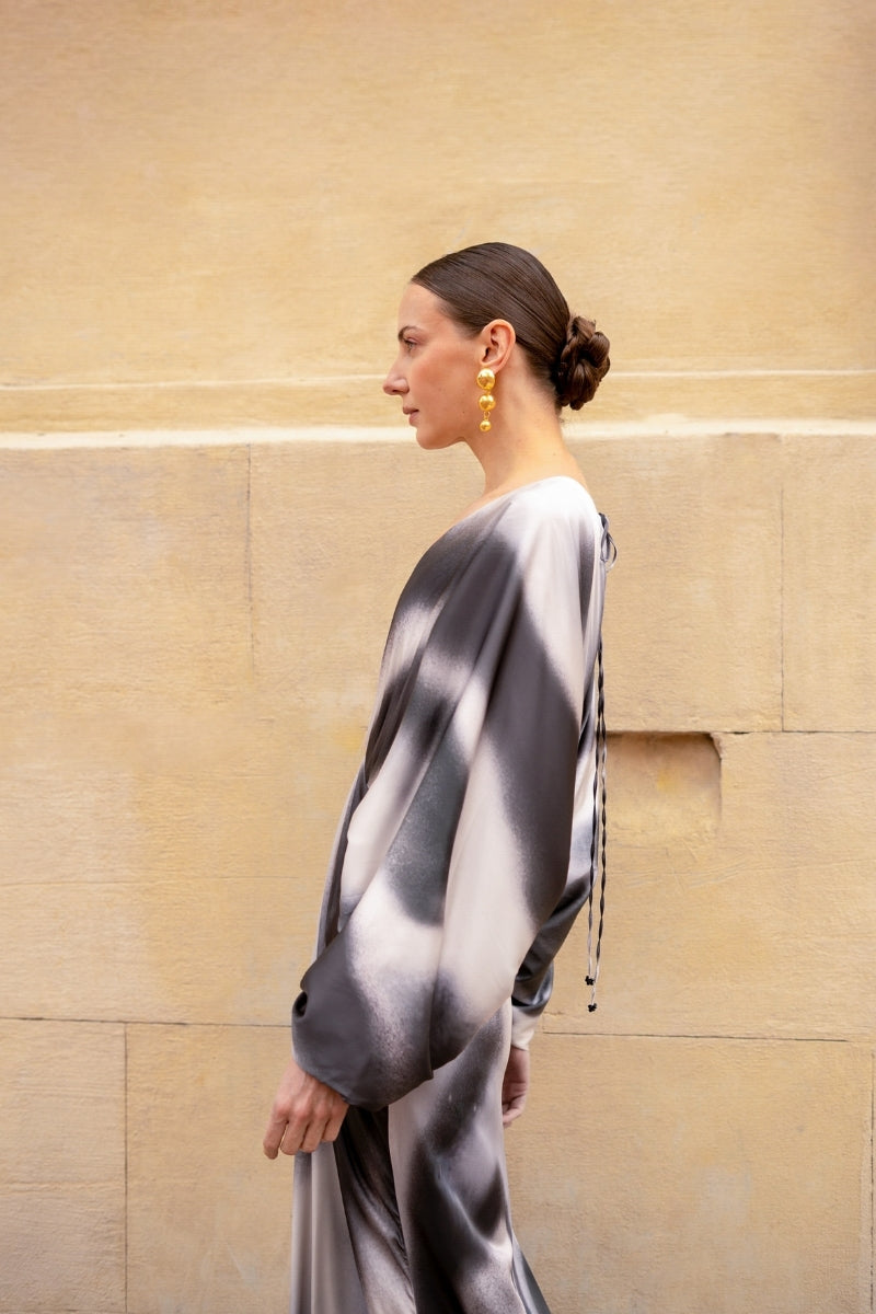 Black printed Tinta Latina Floresta maxi dress displayed on a model, showcasing its flowing fabric and stylish design.