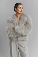 Gray fluffy faux fur jacket by Fortini, shown with a soft, plush texture and stylish design perfect for cold weather wear.