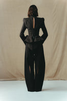 Sean Sheila BESKAP jacket from the back, a stylish tops piece in black with a modern design and fitted silhouette.