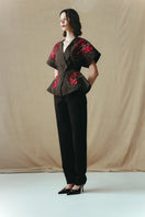 Red embroidered kimono top by Sean Sheila featuring intricate embroidery and a flowing design, shown from the side view.