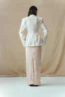 Back view of Sean Sheila satin maxi skirt in blush, flowing floor-length skirt with smooth, shiny fabric and elegant silhouette.