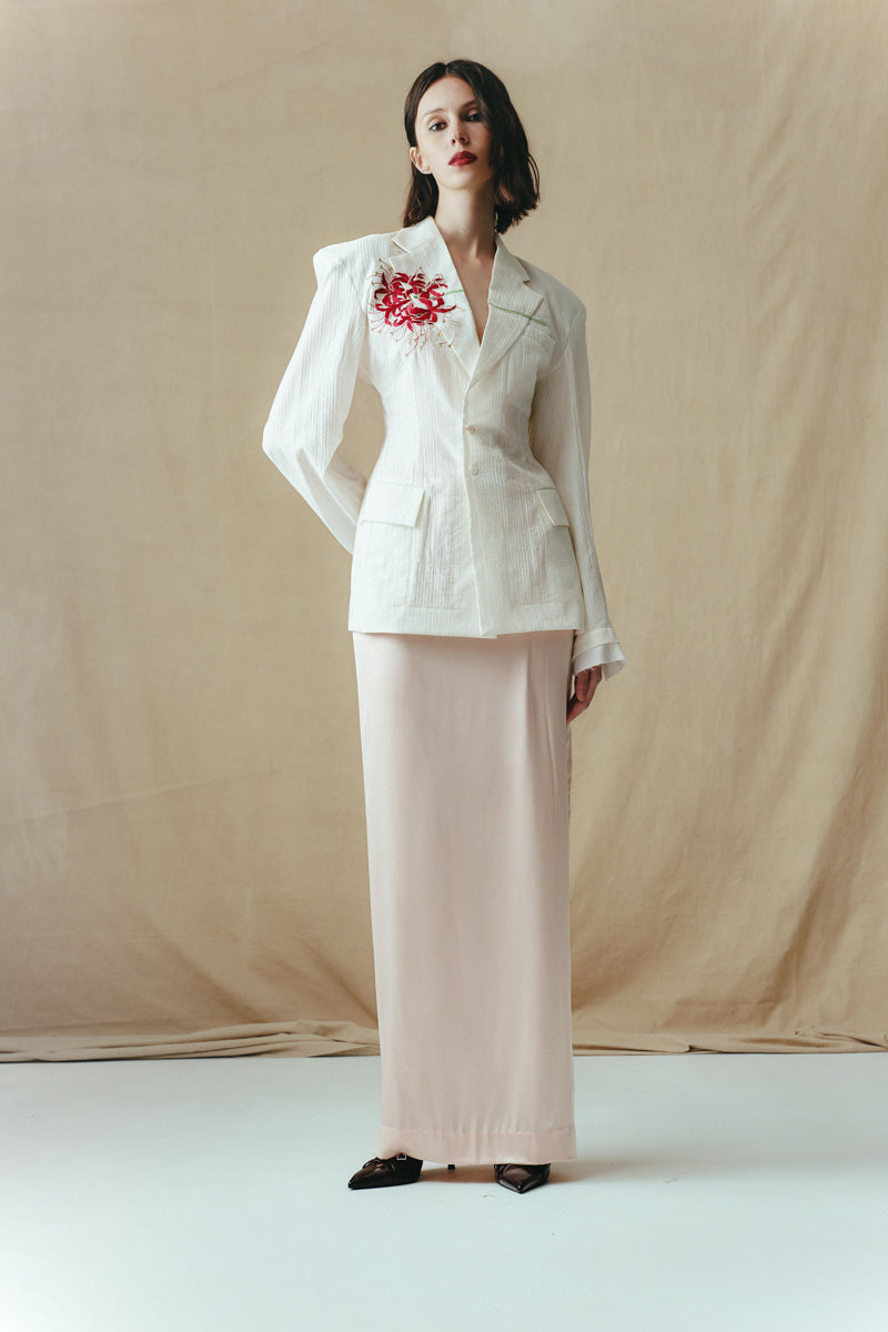 Sean Sheila blush satin maxi skirt, flowing fabric with a sleek, elegant silhouette, shown from the front in the image.