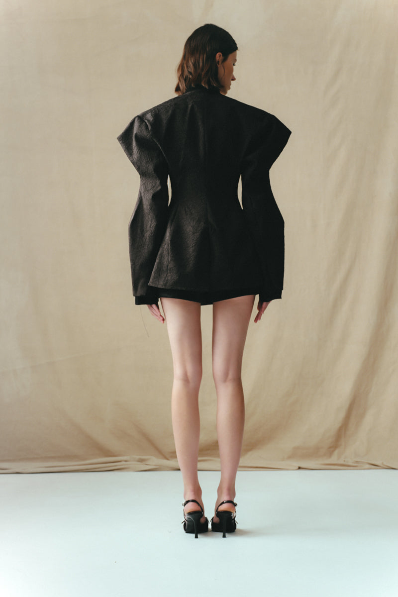 Back view of Sean Sheila double-breasted jacket with embellished buttons, showcasing stylish tailoring and detailed button accents.
