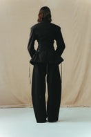 Black cowboy trousers from Sean Sheila, showing the back view with detailed stitching and classic Western-inspired design.