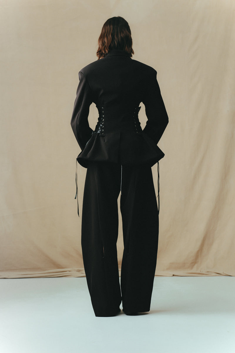 Black cowboy trousers from Sean Sheila, showing the back view with detailed stitching and classic Western-inspired design.